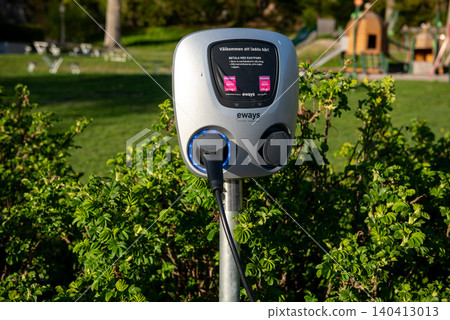 electric vehicle charging station in green public park electric vehicle charging station in green public park 140413013