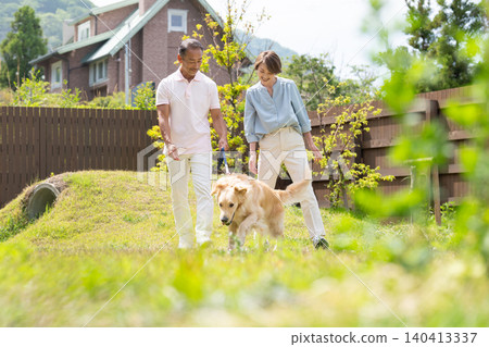 A senior couple enjoying a trip with their beloved dog. 140413337