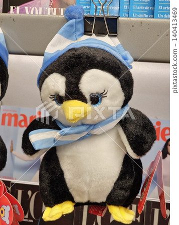 Buenos Aires, Argentina - March 29, 2026: Plush penguin souvenir with Argentine-themed accessories in a duty free display. 140413469