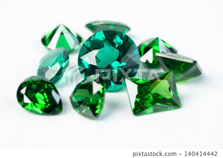 raw emeralds, gemstone jewelry isolated on white background 140414442