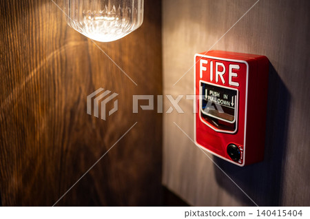 Red fire alarm switch mounted on wooden wall in public building Red fire alarm switch mounted on wooden wall in public building 140415404