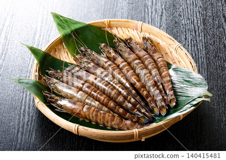 Raw prawns served in a colander Raw prawns served in a colander 140415481