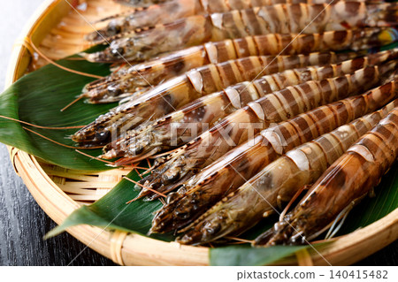 Raw prawns served in a colander Raw prawns served in a colander 140415482