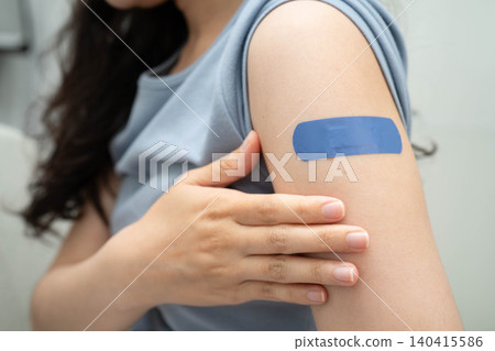 HPV, Human papillomavirus, Asian young woman receiving vaccine with blue bandage. 140415586