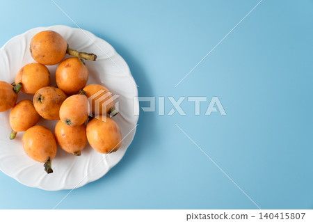 Irregularly shaped, organic, ripe loquats as background material | Natural imperfections and discoloration remain. Irregularly shaped, organic, ripe loquats as background material | Natural imperfections and discoloration remain. 140415807