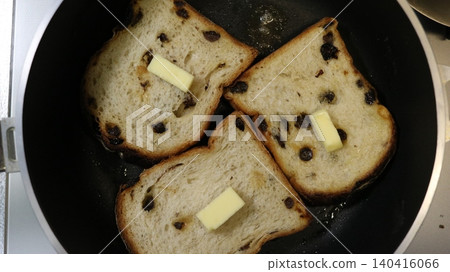 Toast the raisin bread in a frying pan. 140416066