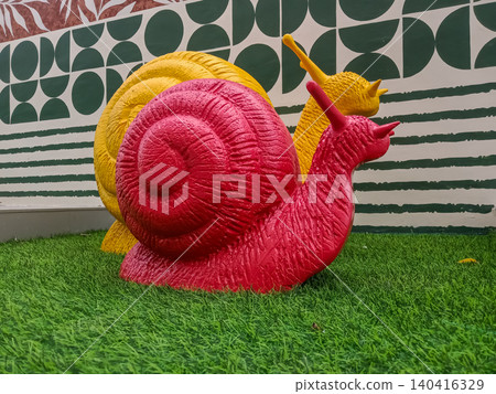 whimsical outdoor art installation featuring two large, textured fiberglass snail statues whimsical outdoor art installation featuring two large, textured fiberglass snail statues 140416329