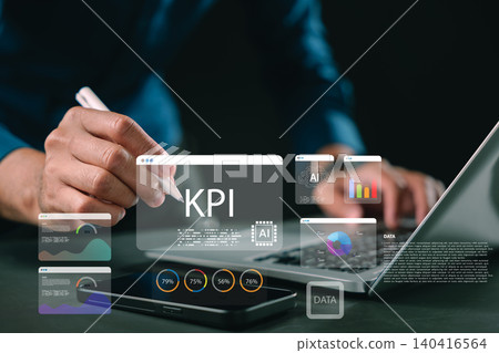 KPI dashboard features data analytics using ai technology, showing person holding pen to track business intelligence and performance visualization for digital strategy on laptop and phone 140416564