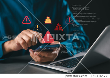 Warning signs show computer cybersecurity threats like data hacking and ransomware, phishing and spyware alert user of cybercrime attack as warning triangle alert symbols show on phone screen Warning signs show computer cybersecurity threats like data hacking and ransomware, phishing and spyware alert user of cybercrime attack as warning triangle alert symbols show on phone screen 140416577