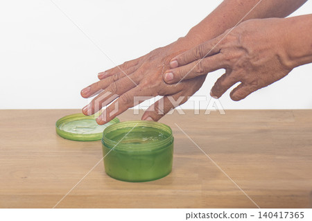 Senior man apply aloe vera gel on skin peeling hand. Senior man apply aloe vera gel on skin peeling hand. 140417365