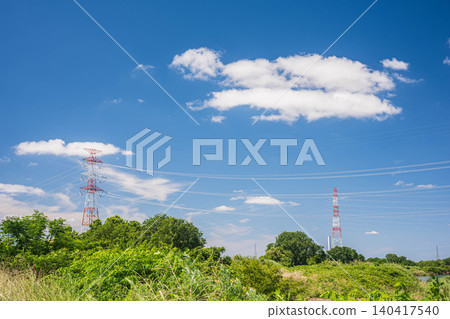 A transmission tower stands on the Yodogawa River embankment in Hirakata City, Osaka Prefecture. A transmission tower stands on the Yodogawa River embankment in Hirakata City, Osaka Prefecture. 140417540