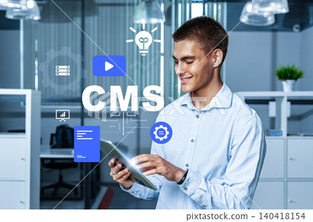 Man uses tablet to manage Content Management System in office Man uses tablet to manage Content Management System in office 140418154