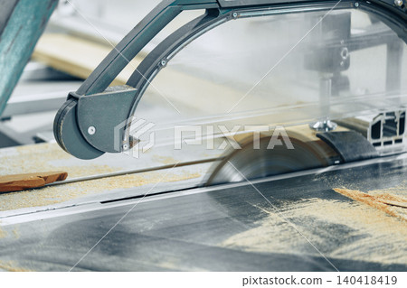 Cutting wood in a furniture workshop during the day using a circular saw 140418419
