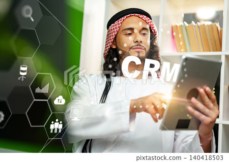 Professional using CRM software on a tablet in an office setting 140418503