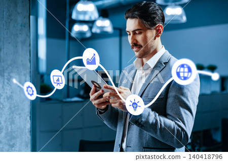 Man using a tablet to manage content in an office setting during working hours Man using a tablet to manage content in an office setting during working hours 140418796
