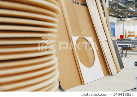 Furniture workshop shows materials stacked against the wall and prepared for crafting 140418825