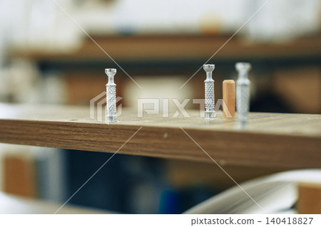 Tools and materials on a workspace in a furniture workshop showing preparation for assembly Tools and materials on a workspace in a furniture workshop showing preparation for assembly 140418827
