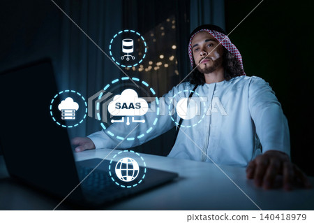 Man works on a laptop while exploring SaaS concepts in a modern workspace Man works on a laptop while exploring SaaS concepts in a modern workspace 140418979