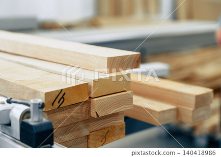 Wooden boards stacked in a furniture workshop during a busy workday 140418986