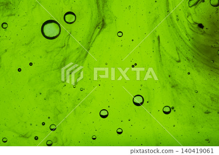 Close-up of dynamic air bubbles floating in a vibrant green textured fluid background Close-up of dynamic air bubbles floating in a vibrant green textured fluid background 140419061
