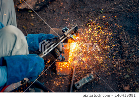 Cutting steel with gas, gas welding and oxy-fuel cutting are processes that use fuel gases and oxygen to weld and cut metals, respectively. industrial worker cutting thick steel in workshop. Cutting steel with gas, gas welding and oxy-fuel cutting are processes that use fuel gases and oxygen to weld and cut metals, respectively. industrial worker cutting thick steel in workshop. 140419091