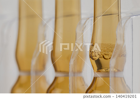 Shallow depth of field shot of pharmaceutical brown vials showcasing bubbles inside the liquid Shallow depth of field shot of pharmaceutical brown vials showcasing bubbles inside the liquid 140419201
