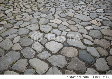 High-angle shot of irregular stone pavers with natural gray tones and weathered textures High-angle shot of irregular stone pavers with natural gray tones and weathered textures 140419317