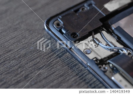 Macro view of smartphone hardware with wires and circuits, moody lighting, shallow depth of field Macro view of smartphone hardware with wires and circuits, moody lighting, shallow depth of field 140419349
