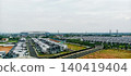 Minimalist housing complex with a stadium in the distance 140419404