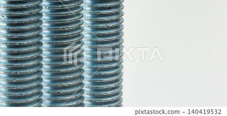 High-detail shot of parallel threaded metal bolts showing texture and industrial pattern High-detail shot of parallel threaded metal bolts showing texture and industrial pattern 140419532