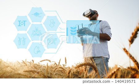 Man using virtual reality in a smart farm field while monitoring crops and technology Man using virtual reality in a smart farm field while monitoring crops and technology 140419571