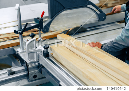 Workers cut wood in furniture workshop during daytime for furniture making projects Workers cut wood in furniture workshop during daytime for furniture making projects 140419642