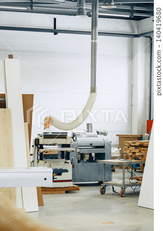 Furniture workshop is busy with machines and tools in action during the day Furniture workshop is busy with machines and tools in action during the day 140419680
