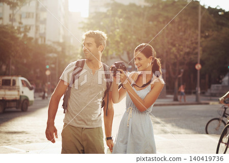 Couple, tourist and photography in street for travel, sightseeing and happiness on holiday or vacation in Brazil. Camera, man and woman with smile in city road for explore, tourism or journey in town 140419736