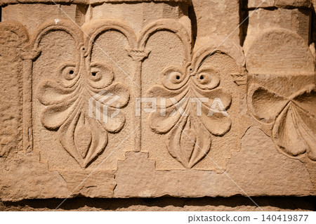 Floral decorative relief carvings on the exterior sandstone wall of an ancient monastery Floral decorative relief carvings on the exterior sandstone wall of an ancient monastery 140419877