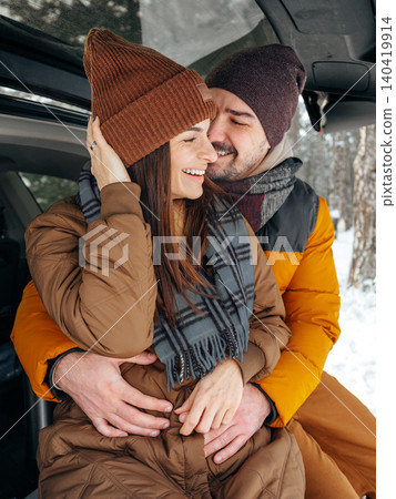 enjoys time together in snow covered forest during winter afternoon enjoys time together in snow covered forest during winter afternoon 140419914