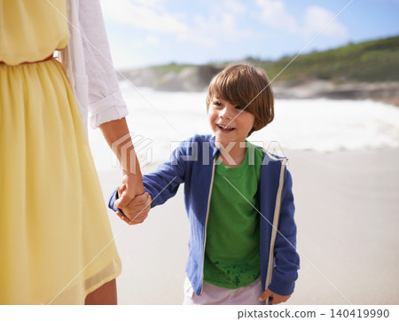 Walking, kid and mother on the beach holding hands in summer, holiday or vacation with happiness in Florida. Happy, child and mom relax on sand together at ocean or sea for adventure in Miami 140419990