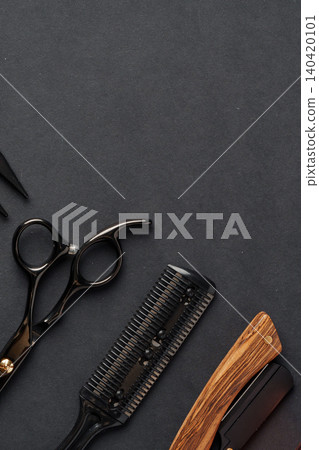 Barber tools arranged on a dark surface at a barbershop during the daytime Barber tools arranged on a dark surface at a barbershop during the daytime 140420101