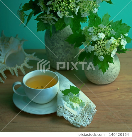 Tea party with bouquets of white viburnum flowers Tea party with bouquets of white viburnum flowers 140420164