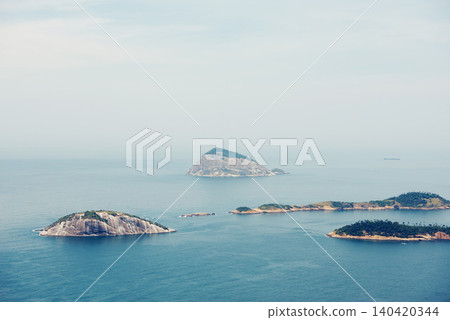 Ocean, nature and aerial of island in sea for travel, holiday and vacation destination in summer. Natural background, seascape and islands in water for scenic view in environment, ecosystem and waves Ocean, nature and aerial of island in sea for travel, holiday and vacation destination in summer. Natural background, seascape and islands in water for scenic view in environment, ecosystem and waves 140420344