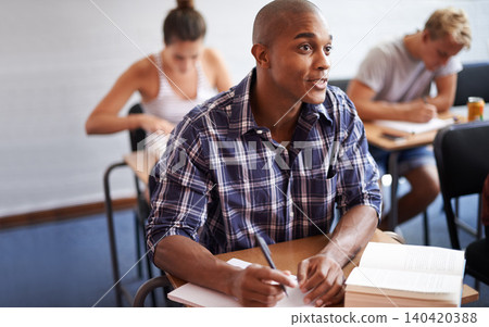 Black man, student and writing with book in classroom for studying, reading or summary at university. African male person or young academic writer with notebook for assignment, test or exam at campus Black man, student and writing with book in classroom for studying, reading or summary at university. African male person or young academic writer with notebook for assignment, test or exam at campus 140420388