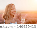 Lavender woman sunset holding purple flowers and a glass of water in a blooming field with warm copy space 140420413