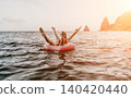 Woman, floating, ocean, enjoying a relaxed summer vacation with mountains and copy space. 140420440