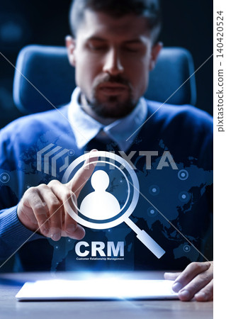 Man interacting with CRM system on a digital interface in an office setting 140420524