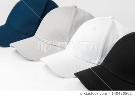 Various caps arranged in a line showing different colors and styles for casual wear 140420862