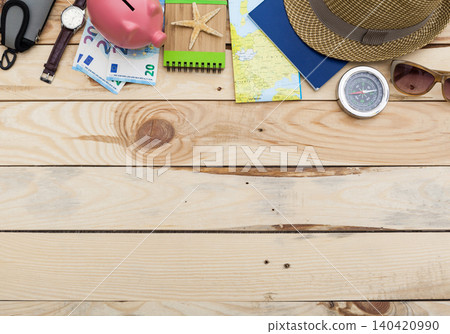 Travel items and tools on wooden table for planning a trip in summer time Travel items and tools on wooden table for planning a trip in summer time 140420990