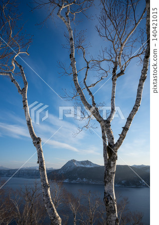 Mount Mashu and birch trees standing under the blue sky of Hokkaido Mount Mashu and birch trees standing under the blue sky of Hokkaido 140421015