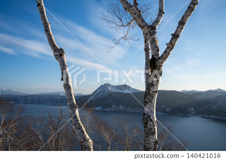 Mount Mashu and birch trees standing under the blue sky of Hokkaido Mount Mashu and birch trees standing under the blue sky of Hokkaido 140421016