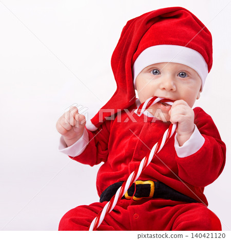 Baby, portrait and studio with santa costume for first Christmas holiday, candy cane and white background. Boy toddler, xmas and outfit for festive season or celebration, innocent and adorable in hat Baby, portrait and studio with santa costume for first Christmas holiday, candy cane and white background. Boy toddler, xmas and outfit for festive season or celebration, innocent and adorable in hat 140421120