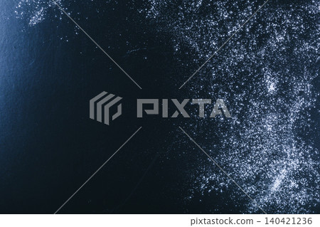 Flour scattered on a dark surface during a cooking session in the kitchen Flour scattered on a dark surface during a cooking session in the kitchen 140421236